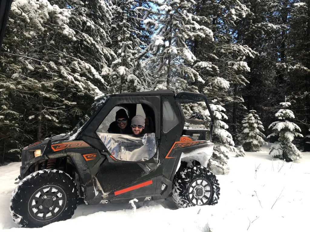 Travis and Rachel in RZR and snow sledding.